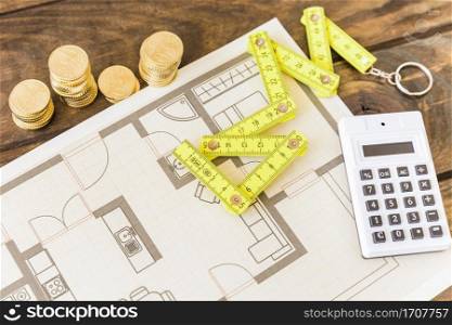 high angle view measure tape calculator stacked coins blueprint