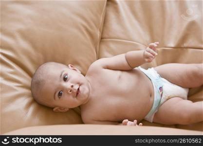 High angle view of a baby boy lying on a couch