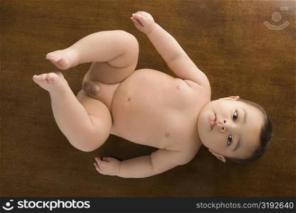 High angle view of a baby boy lying on the floor