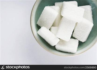 High angle view of a bowl of sugar cubes
