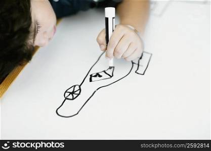 High angle view of a boy drawing sketch