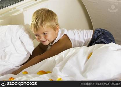 High angle view of a boy lying on the bed