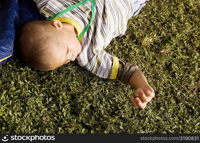 High angle view of a boy lying on the grass