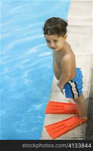 High angle view of a boy standing by the pool