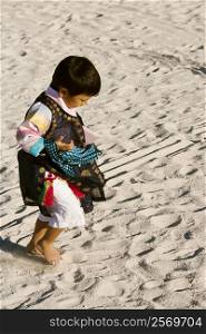 High angle view of a boy walking on the sand