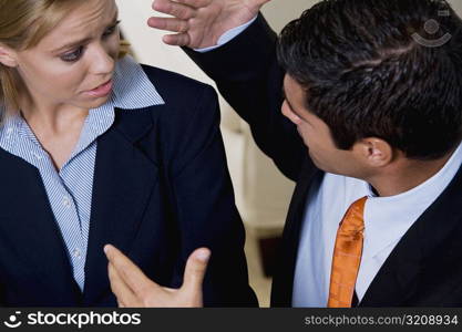 High angle view of a businessman and a businesswoman discussing