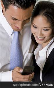 High angle view of a businessman and a businesswoman operating a mobile phone