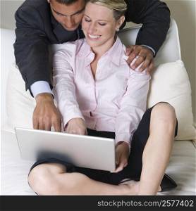 High angle view of a businessman and a businesswoman using a laptop