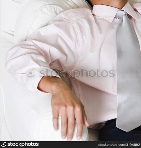 High angle view of a businessman sleeping in an armchair