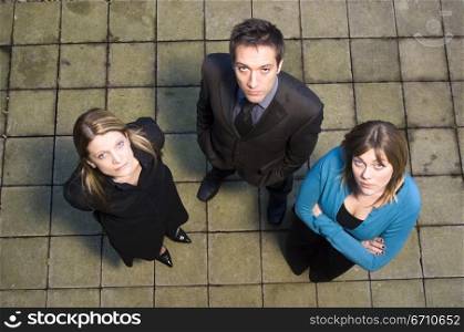 High angle view of a businessman standing with two businesswomen