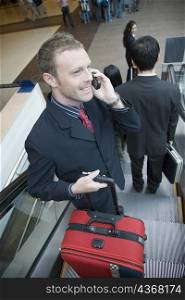 High angle view of a businessman talking on a mobile phone and smiling