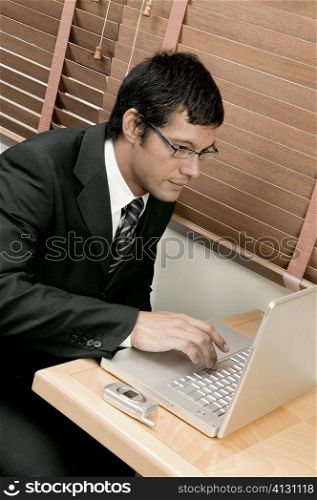 High angle view of a businessman using a laptop
