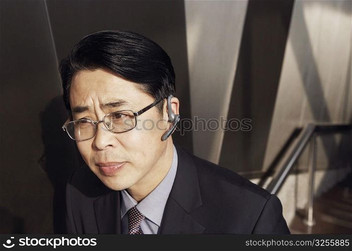 High angle view of a businessman wearing a hands free device