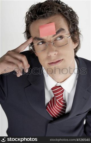 High angle view of a businessman with an adhesive note on his forehead