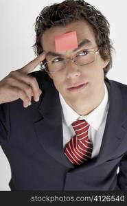 High angle view of a businessman with an adhesive note on his forehead