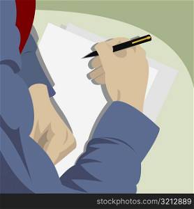 High angle view of a businessman writing on paper