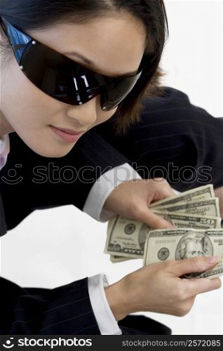 High angle view of a businesswoman holding American paper currency