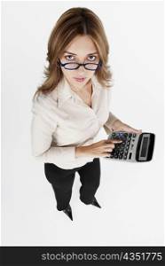 High angle view of a businesswoman using a calculator