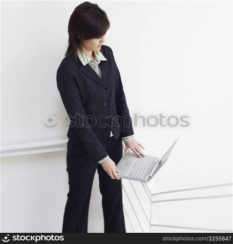 High angle view of a businesswoman using a laptop on the staircase