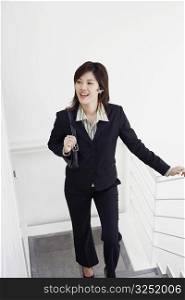 High angle view of a businesswoman walking up a staircase and smiling