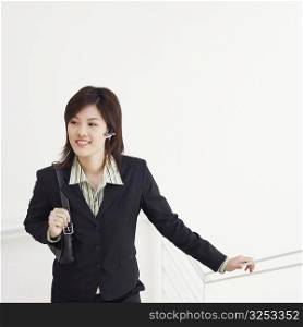 High angle view of a businesswoman walking up a staircase and smiling