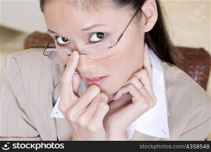 High angle view of a businesswoman with her finger on her eyeglasses