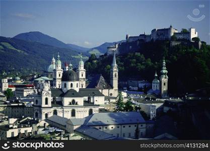 High angle view of a cathedral with a fort on top of a hill, Kollegienkirche, Hohensalzburg Fortress, Salzburg, Austria