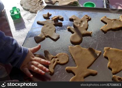 High angle view of a child&acute;s hand making cookies