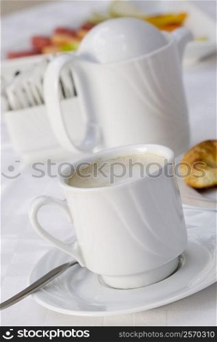 High angle view of a coffee cup and a kettle