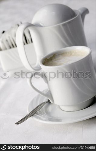 High angle view of a coffee cup and a kettle