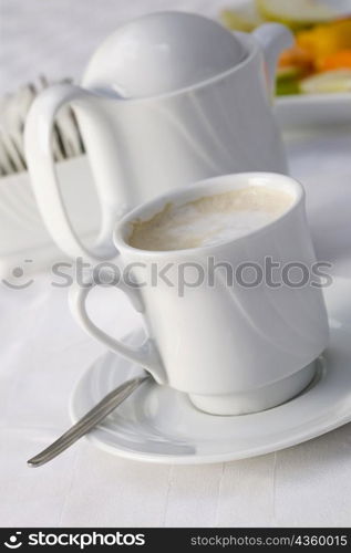 High angle view of a coffee cup and a kettle