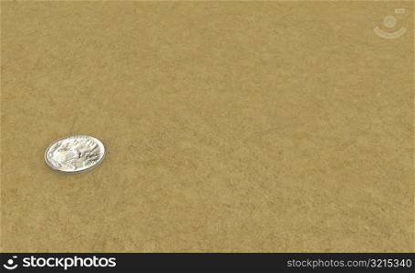 High angle view of a coin on sand