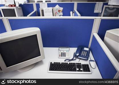 High angle view of a computer with a telephone on a desk