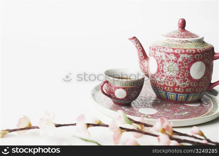 High angle view of a cup of black tea and a teapot on a tray