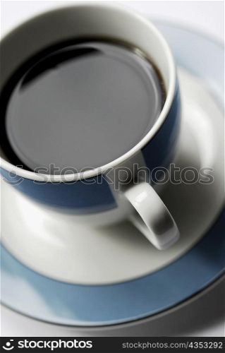 High angle view of a cup of black tea on a saucer