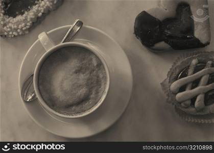 High angle view of a cup of coffee with snacks