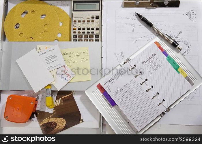 High angle view of a diary with a calculator on the table
