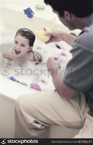 High angle view of a father giving his daughter a bath