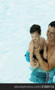 High angle view of a father with his son in a swimming pool