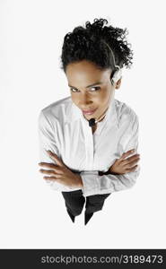 High angle view of a female customer service representative standing with her arms folded