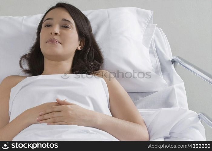High angle view of a female patient lying on the bed