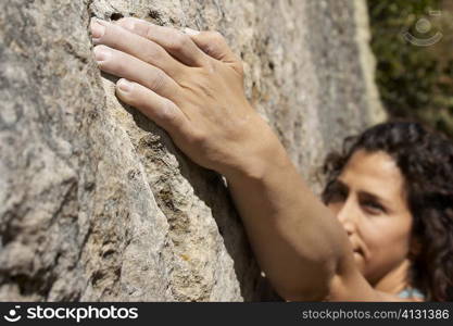 High angle view of a female rock climber scaling a rock face