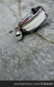 High angle view of a fishing reel and a fishing rod