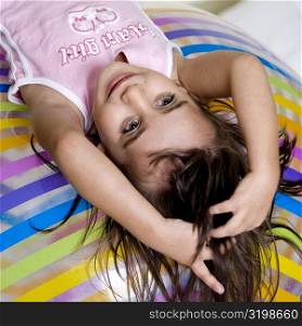 High angle view of a girl lying on an inflatable ball