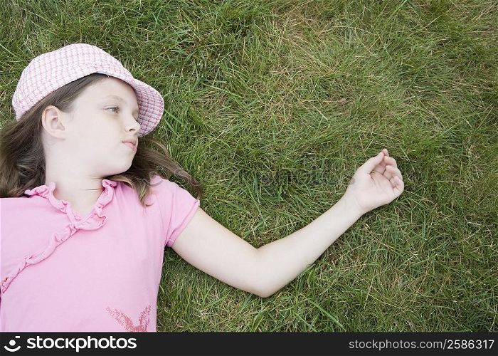 High angle view of a girl lying on grass