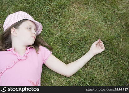 High angle view of a girl lying on grass