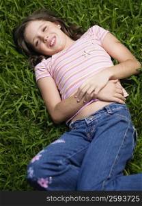 High angle view of a girl lying on the grass