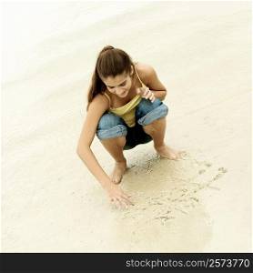 High angle view of a girl playing tic-tac-toe on the beach