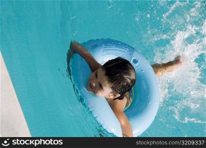 High angle view of a girl swimming with an inflatable ring