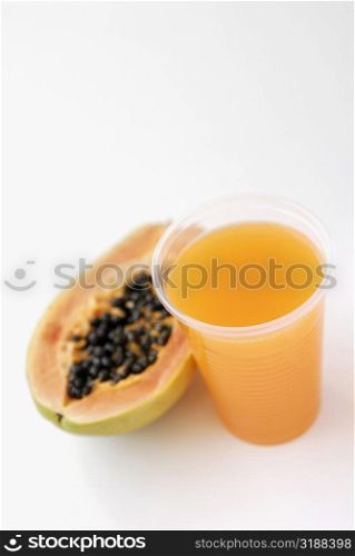 High angle view of a glass of juice with a papaya